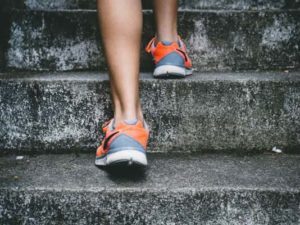 This image shows a close up of persons sports trainers running up concrete stairs. St Albans Personal Training and Programmes are challenging, dynamic, and most importantly achieve great results!